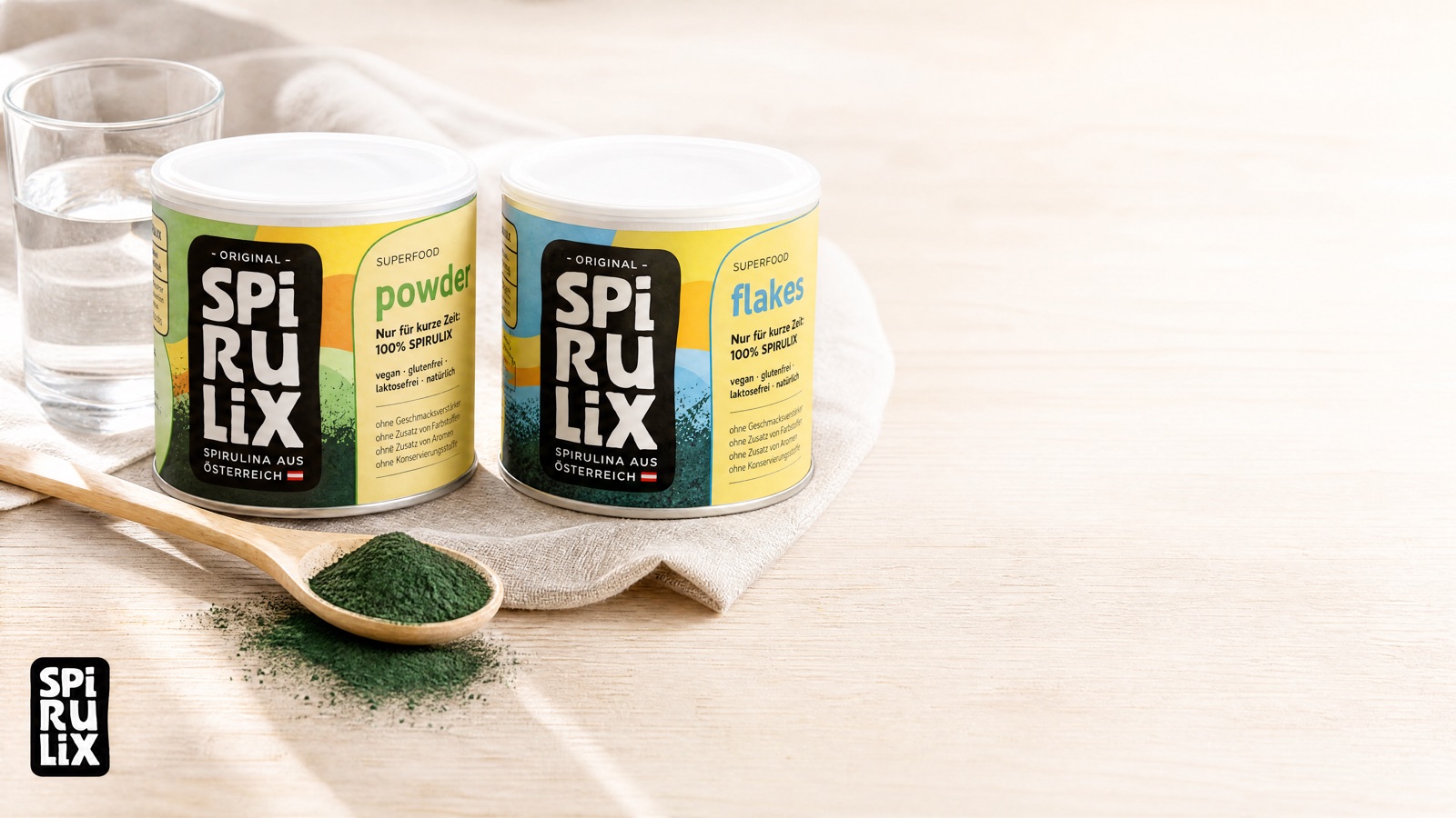 Two tins on linen, spoon of powder